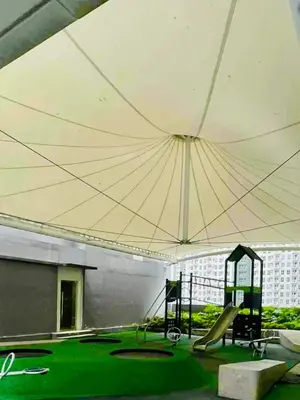 a playground with a large tent with a slide at JL's City Hideaway at Fame Residences in Manila