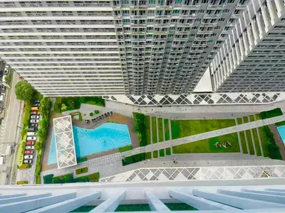an overhead view of a building with a swimming pool at JL's City Hideaway at Fame Residences in Manila