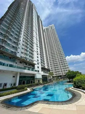 a large building with a large swimming pool in front of it at Next Abode 1BR at TheBeaconMakati in Manila