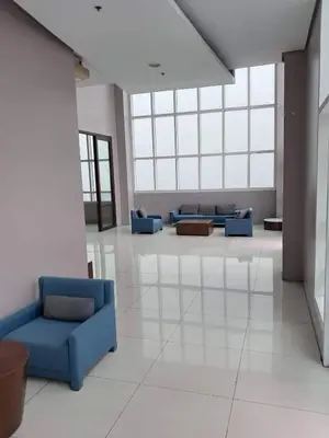 a lobby with blue couches in a building at Next Abode Modern Stay at TheBeaconMakatiRoces in Manila