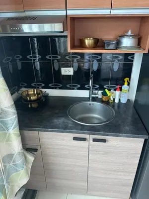 a kitchen counter with a sink in a kitchen at Next Abode Modern Stay at TheBeaconMakatiRoces in Manila