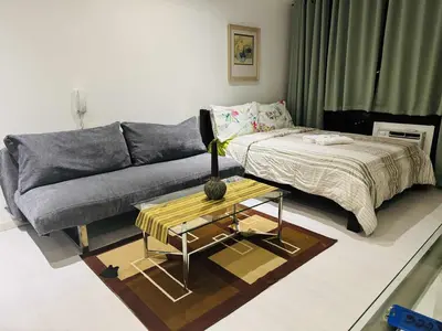 a living room with a couch and a table at The Gramercy Residences in Manila