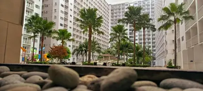 a view of a city with palm trees and buildings at DIRECT TO POOL Shore Residences by heart in Manila