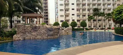a swimming pool in the middle of a large building at DIRECT TO POOL Shore Residences by heart in Manila