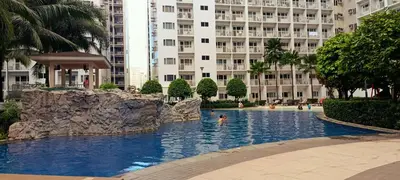a swimming pool in the middle of a large building at DIRECT TO POOL Shore Residences by heart in Manila