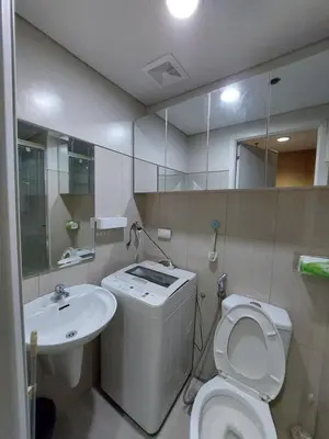 a bathroom with a toilet and a sink at Condotel SM MOA sea residences in Manila
