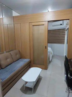 a small room with a couch and a table at Condotel SM MOA sea residences in Manila