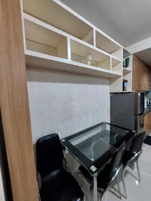a dining room with a glass table and chairs at She'll residences condotel in Manila