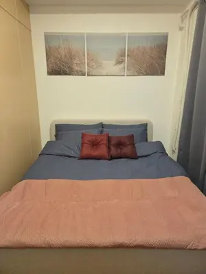 a bedroom with a bed with two pillows on it at CL Urban Homestay Cozy 1BR near BGC & NAIA in Manila