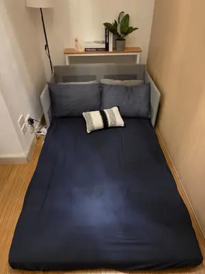 a bed with a blue bed frame in a room at CL Urban Homestay Cozy 1BR near BGC & NAIA in Manila
