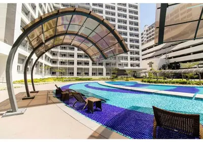 an overhead view of a swimming pool in a building at CL Urban Homestay Cozy 1BR near BGC & NAIA in Manila