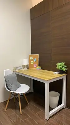 a desk with a chair and a box on it at Cozy & Affordable Stay in Air Residences in Manila