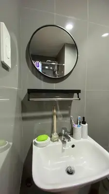 a bathroom with a white sink and a mirror at Cozy & Affordable Stay in Air Residences in Manila