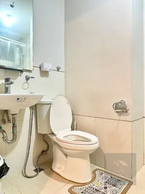 a bathroom with a toilet and a sink at Cozy Modern Studio Unit with PS4 at The Sentinel Residences, Cubao in Manila