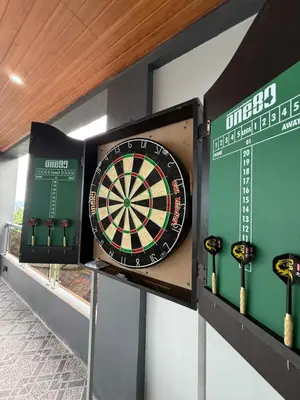 a dart board on a wall with some darts at Bella Tamara Private Resort in Binangonan