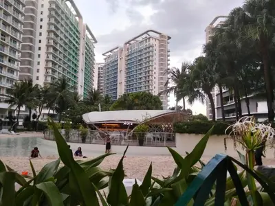 a park in the middle of a city with tall buildings at OasisStaycation in Manila