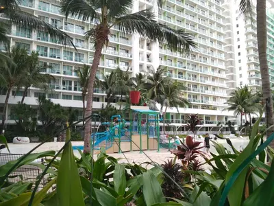 a playground in front of a large apartment building at OasisStaycation in Manila