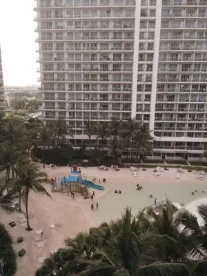 a beach in front of a large building at OasisStaycation in Manila