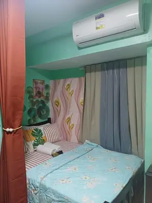 a bed in a room with avertisementatronatronstrationbestosbestosbestosbestosbestos at Dencios transient