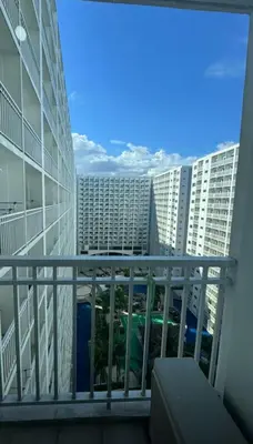 a balcony with a view of some buildings at At The Shore in Manila