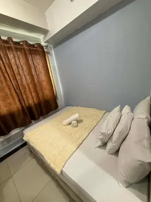 a bed in a room with a window at Staycation at Sea Residences MOA Pasay City in Manila