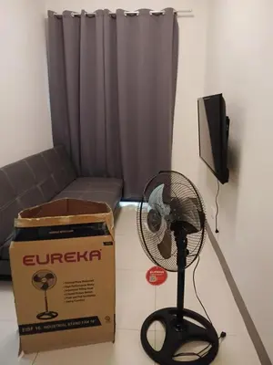 a box and a fan in a living room at Seva Condo Residences in Manila