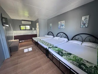 a group of beds in a room at Hidden Leaf Private Resort in Dasmariñas