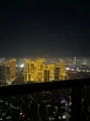 a view of a city at night at Spacious 2BR Mid- Century Modern Home at Gramercy Residences in Manila