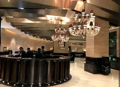 a group of people sitting at a bar in a restaurant at The Gramercy Residences by YYESS in Manila