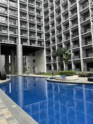 a large apartment building with a large swimming pool at ALFA staycation at Shore 2 tower 1 Pasay City in Manila