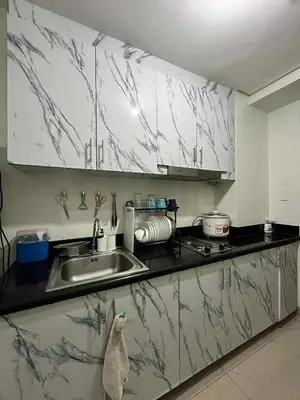 a kitchen with marble counter tops and a sink at ALFA staycation at Shore 2 tower 1 Pasay City in Manila