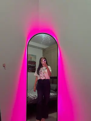 a woman standing in front of a mirror at ALFA staycation at Shore 2 tower 1 Pasay City in Manila