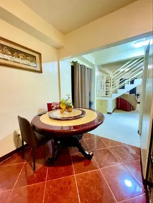 a dining room with a table and a bedroom at Easy Escape in Manila