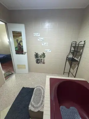 a bathroom with a bath tub in a room at Easy Escape in Manila