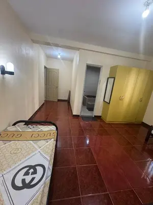 a room with a bed and a tiled floor at Easy Escape in Manila