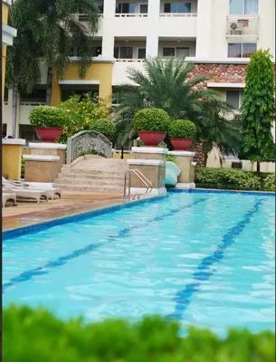 a large swimming pool in front of a building at Secret Nest in Manila