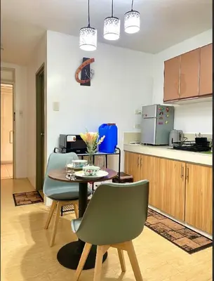 a kitchen with a table and chairs in a kitchen at Secret Nest in Manila
