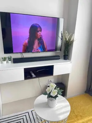 a flat screen tv with a woman on it at Condo Transient by Eugenio Tan in Manila