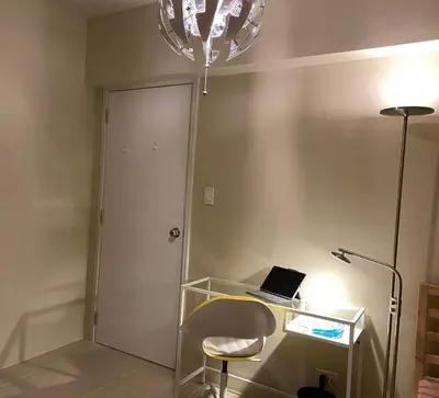 a room with a desk with a laptop and a chair at Vacation at Tolentino Residence in Manila