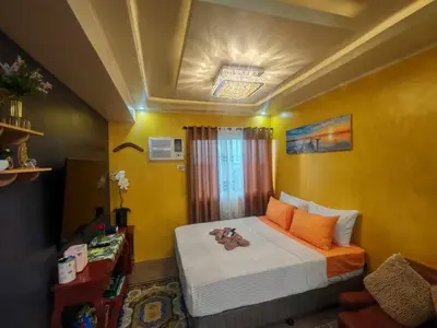 a bedroom with a bed with a teddy bear on it at Escape to Nature Studio Unit in Puting Kahoy
