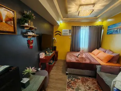 a small bedroom with a bed and a couch at Escape to Nature Studio Unit in Puting Kahoy