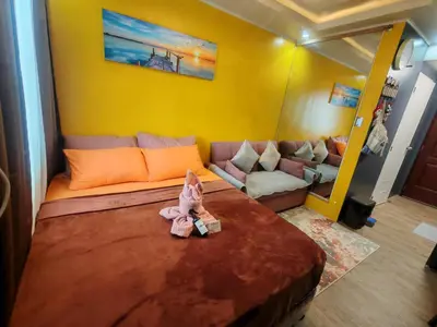 a bedroom with a bed with a stuffed animal on it at Escape to Nature Studio Unit in Puting Kahoy