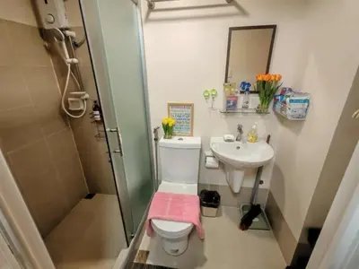 a bathroom with a toilet and a sink and a shower at Escape to Nature Studio Unit in Puting Kahoy
