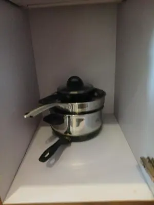 a pot with a black lid sitting on a stove at Bayfront Suite near Airport, MOA, PICC, Star City, OKADA With Fast WIFI & Netflix Free Pool Access in Manila