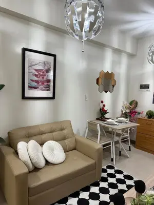 a living room with a couch and a table at stylish 2BR Condo Near NAIA in Manila