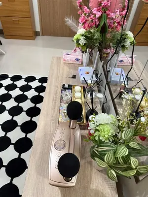 a table with a vase and flowers on it at stylish 2BR Condo Near NAIA in Manila
