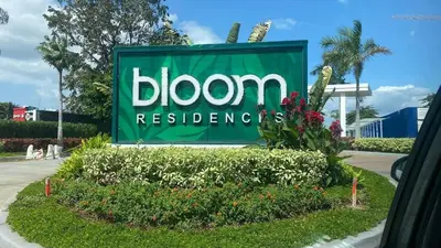 a sign for a bloom technologies sign in a garden at stylish 2BR Condo Near NAIA in Manila