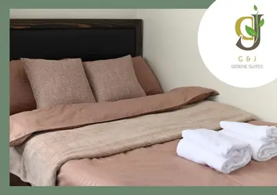 a bed with two towels sitting on top of it at G & J Serene Suites in Tanza