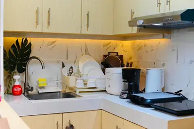a kitchen with a sink and a counter top at G & J Serene Suites in Tanza