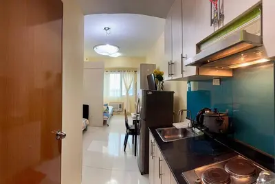 a kitchen with a sink and a refrigerator at Sea Residences Tower B Condotel Look F0R MaV in Manila
